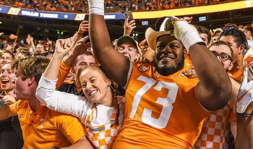 tennessee volunteers football player in the stands with fans